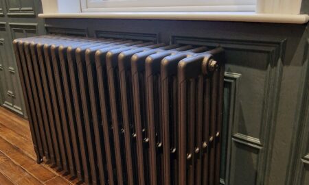 Expert painting and decorating by Lord Hearts Decorating Services featuring a restored cast iron radiator and period wall panelling.